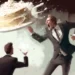 young man throws cake at the man in suit